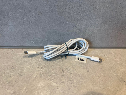 USB-C to USB-C charging cable coiled on a gray surface with 1.8 meter label