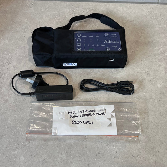 Alliana air cushion pump set with control unit, charger, and power cable on counter
