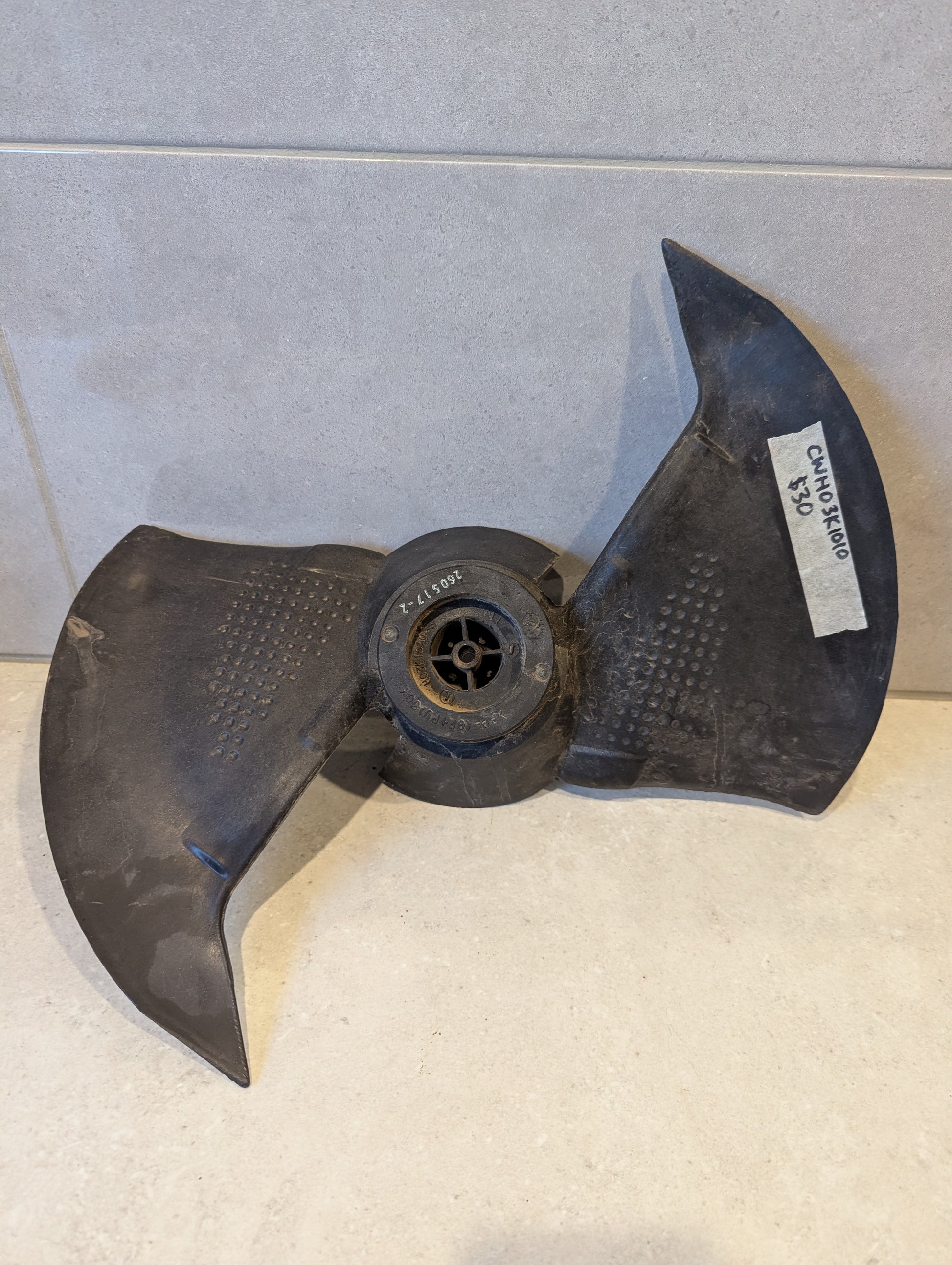 Black plastic dual-blade replacement boat propeller with mounting hub