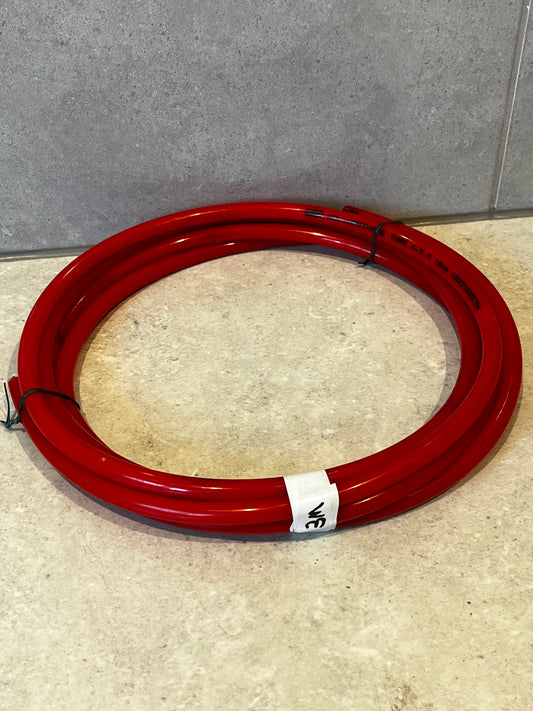 Coiled red polyurethane tube hose on a countertop