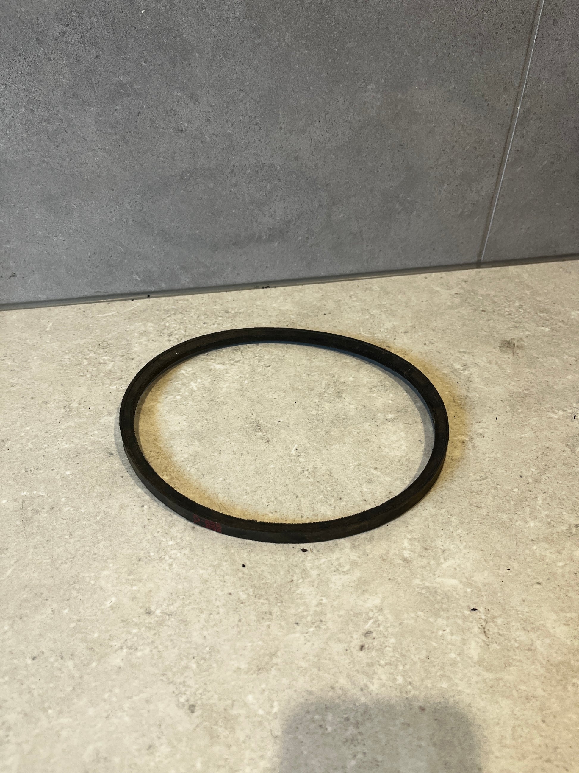 Top view of industrial rubber drive belt on light surface