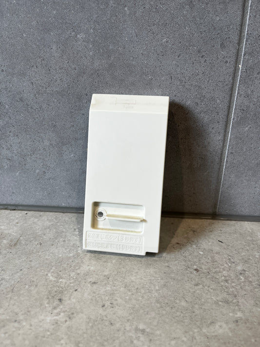 Front view of a white plastic electrical enclosure junction box on a gray surface
