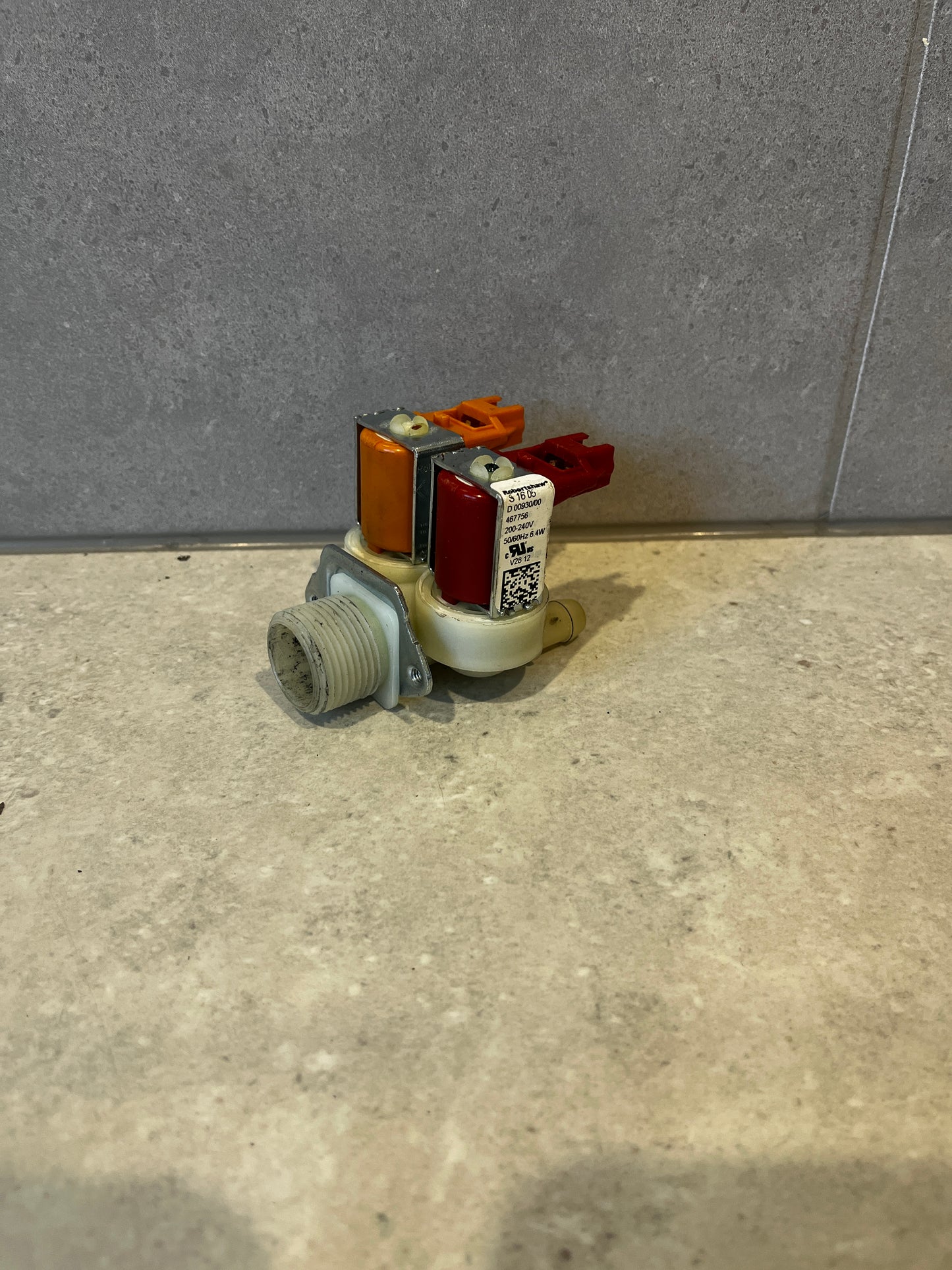 Dual inlet solenoid water valve with color-coded connectors on countertop