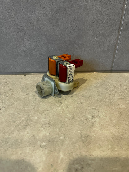 Dual inlet solenoid water valve with color-coded connectors on countertop