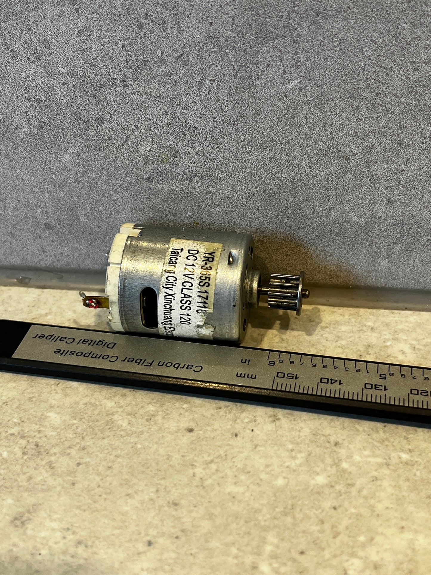 Close-up of DC 12V electric motor with metal pulley attached