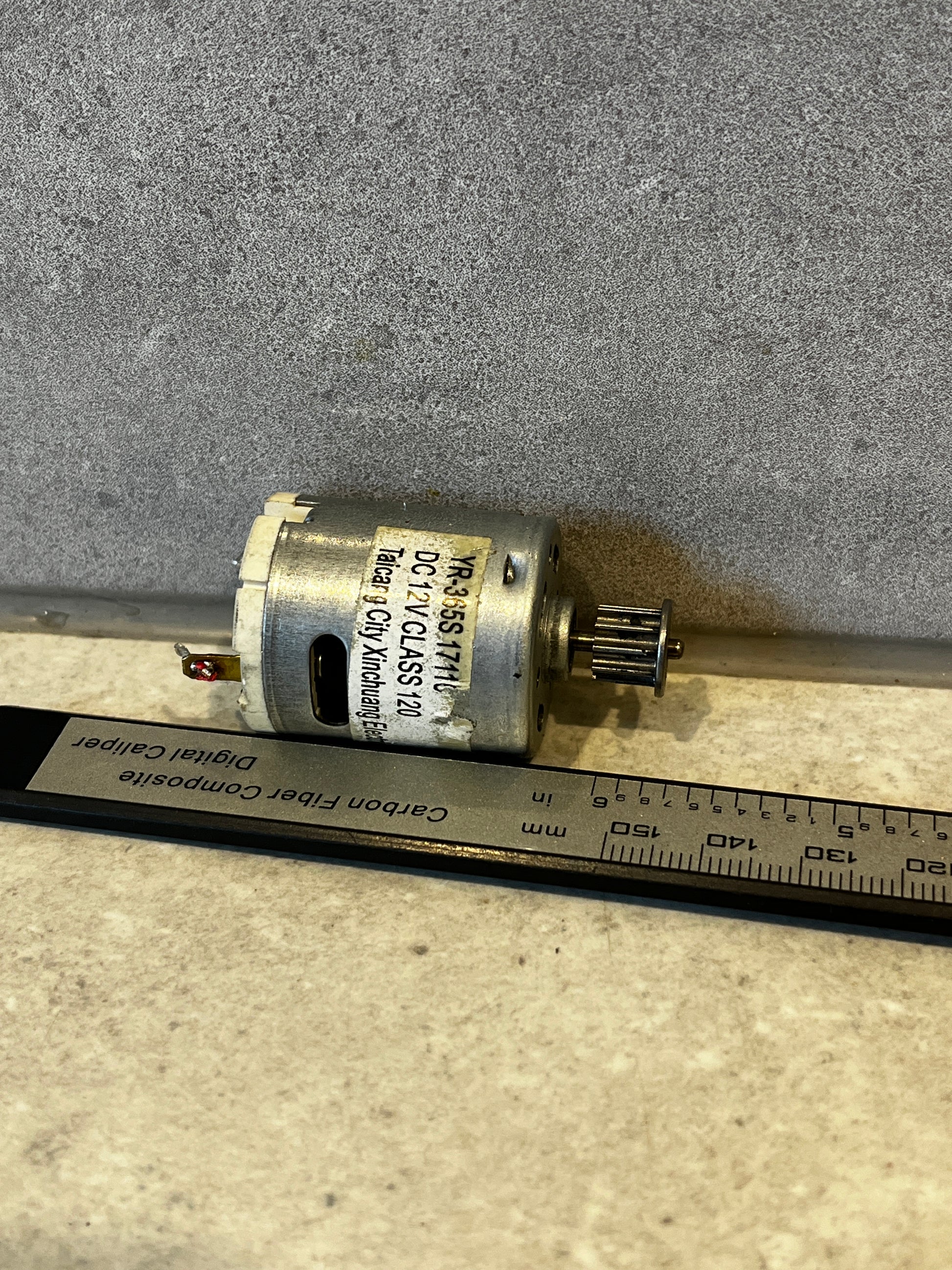 Close-up of DC 12V electric motor with metal pulley attached
