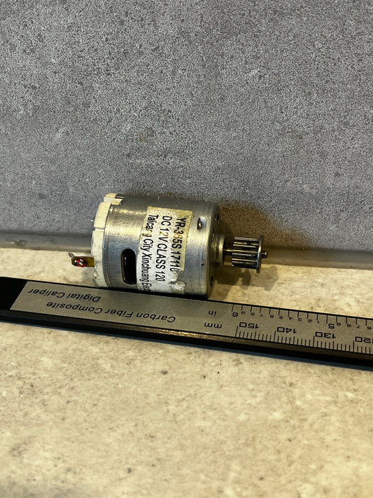 Close-up of DC 12V electric motor with metal pulley attached