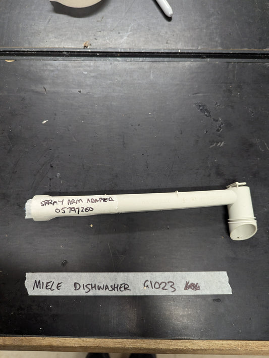 Miele G1023 dishwasher spray arm adapter on black surface