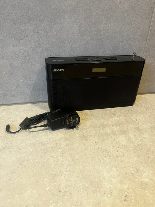 Jensen digital AM/FM radio with AC adapter on countertop