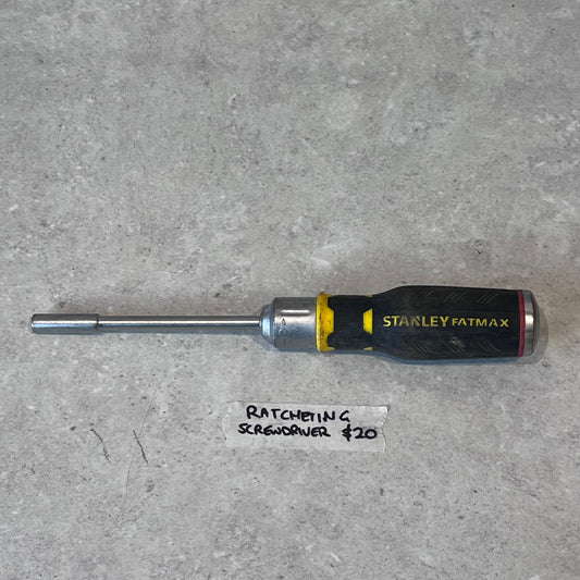 Stanley FatMax ratcheting screwdriver with black and yellow handle on gray surface