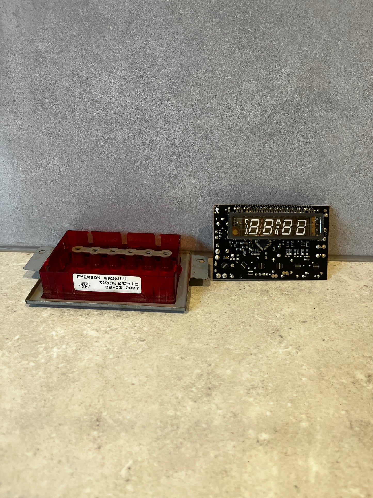 Red plastic and metal digital control board with numeric LED display and mounting bracket