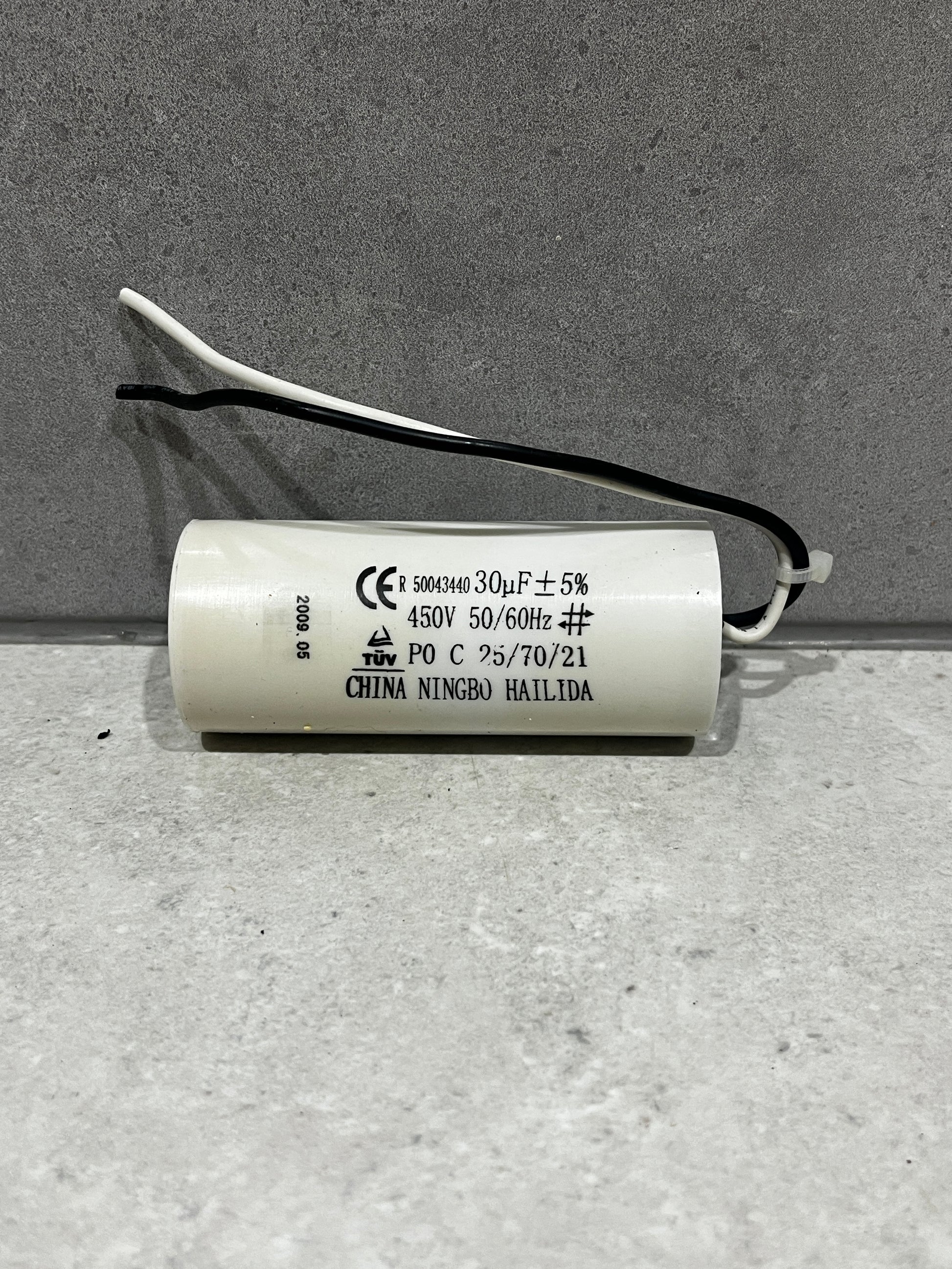 30uF 450V cylindrical run capacitor with attached black and white wires