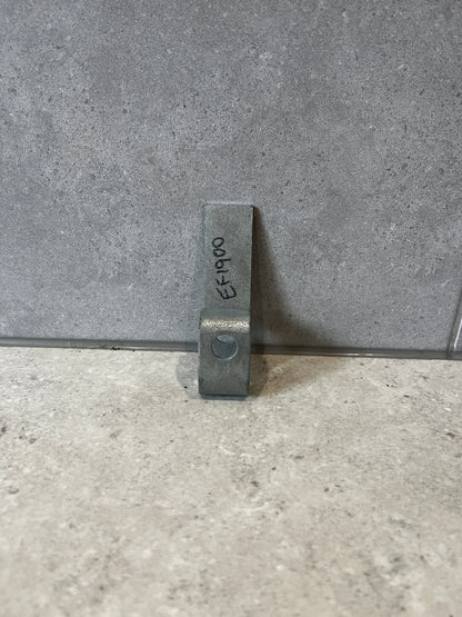 Heavy-duty steel mounting bracket standing upright on a gray stone surface