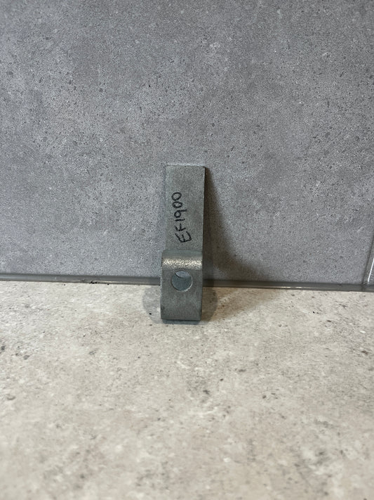 Heavy-duty steel mounting bracket standing upright on a gray stone surface