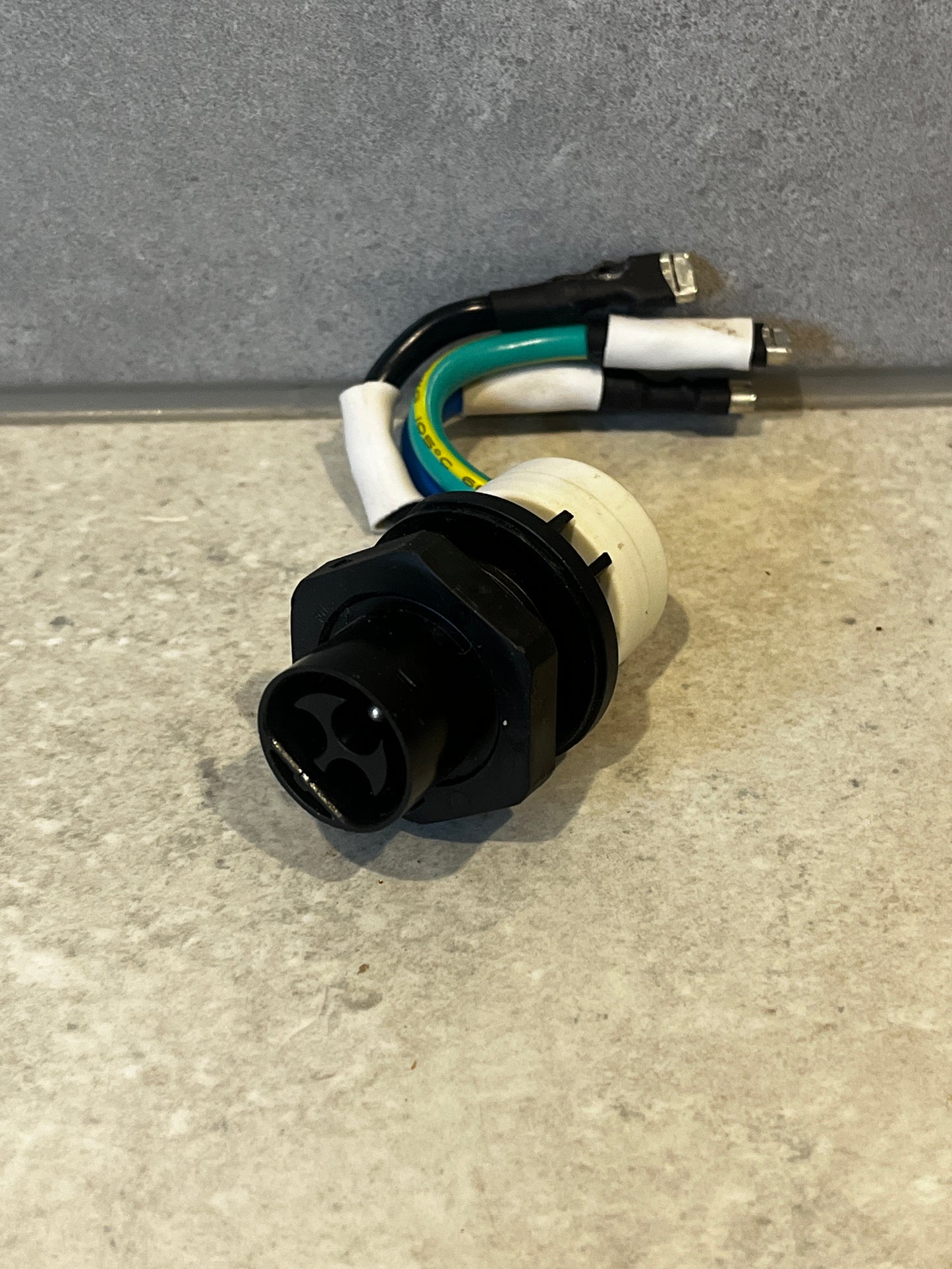 Black and white multi-pin electrical connector with attached colored wires