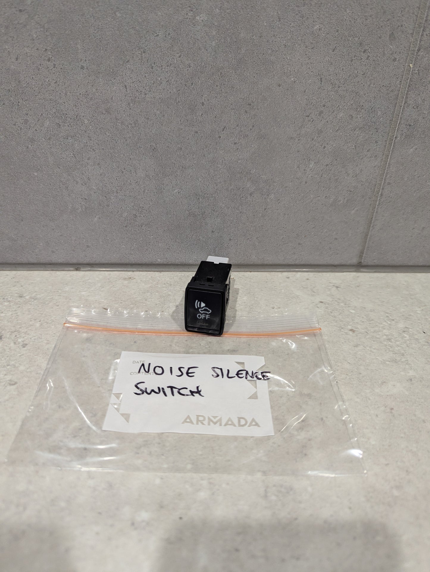 Armada Noise Silence Switch and labeled plastic bag on countertop