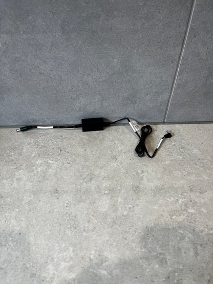 Black DC power adapter cable for TEC-C base shown on gray surface
