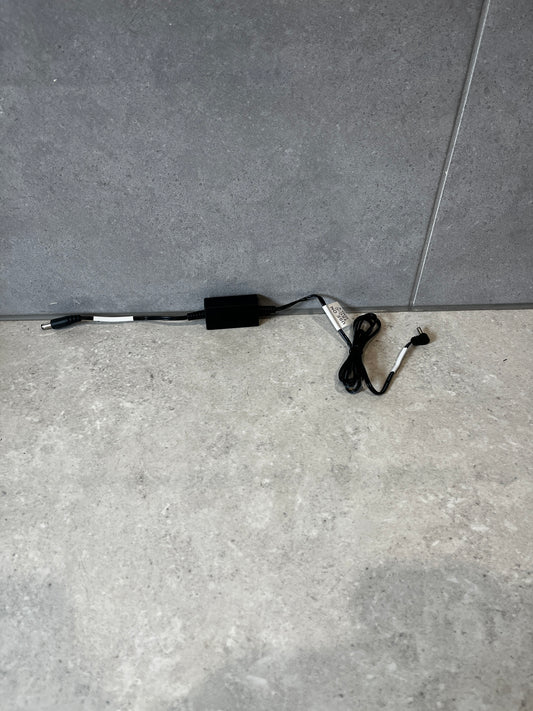 Black DC power adapter cable for TEC-C base shown on gray surface