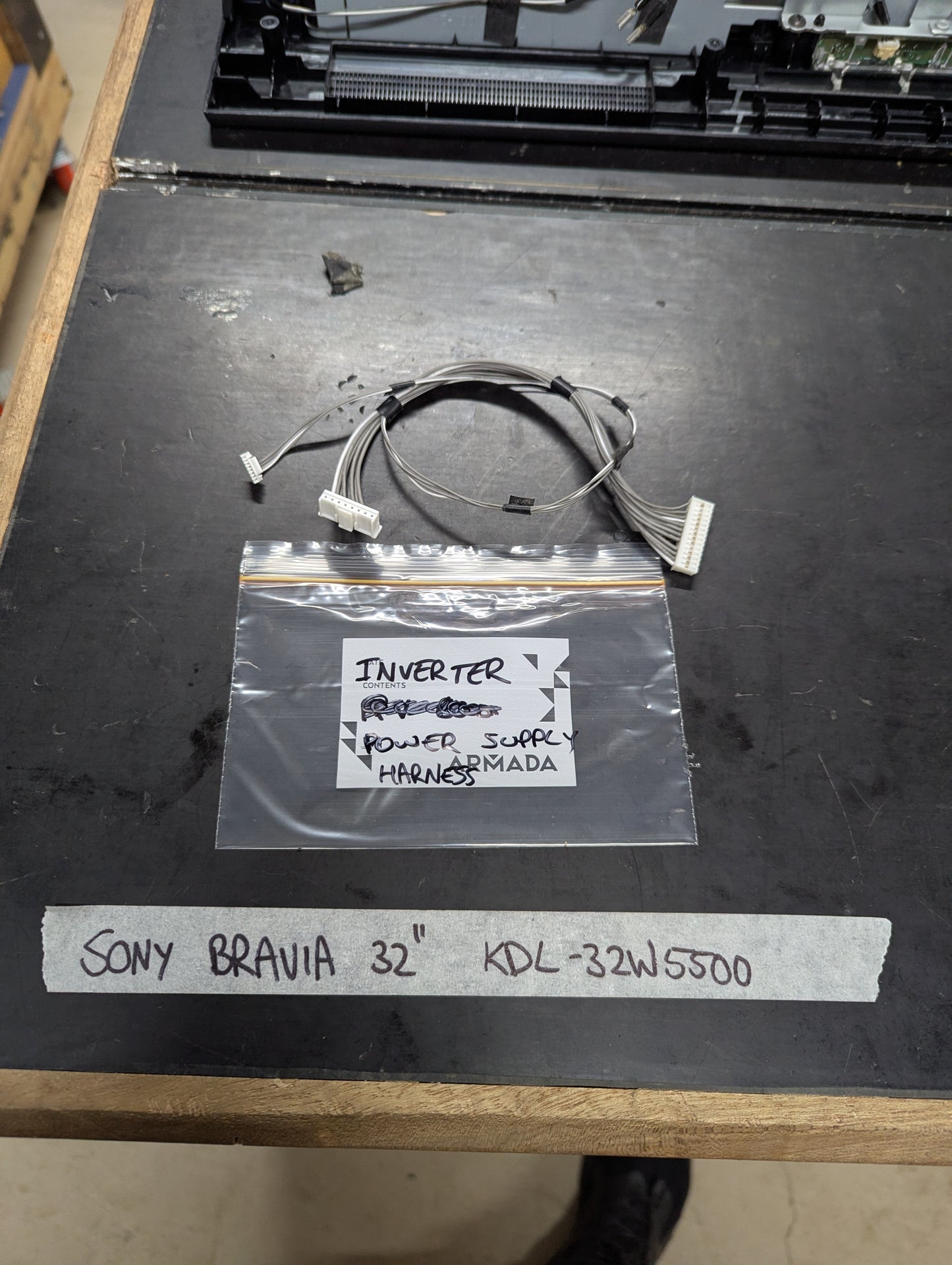 Sony Bravia 32 KDL-32W5500 power supply harness cable and labeled bag on workbench