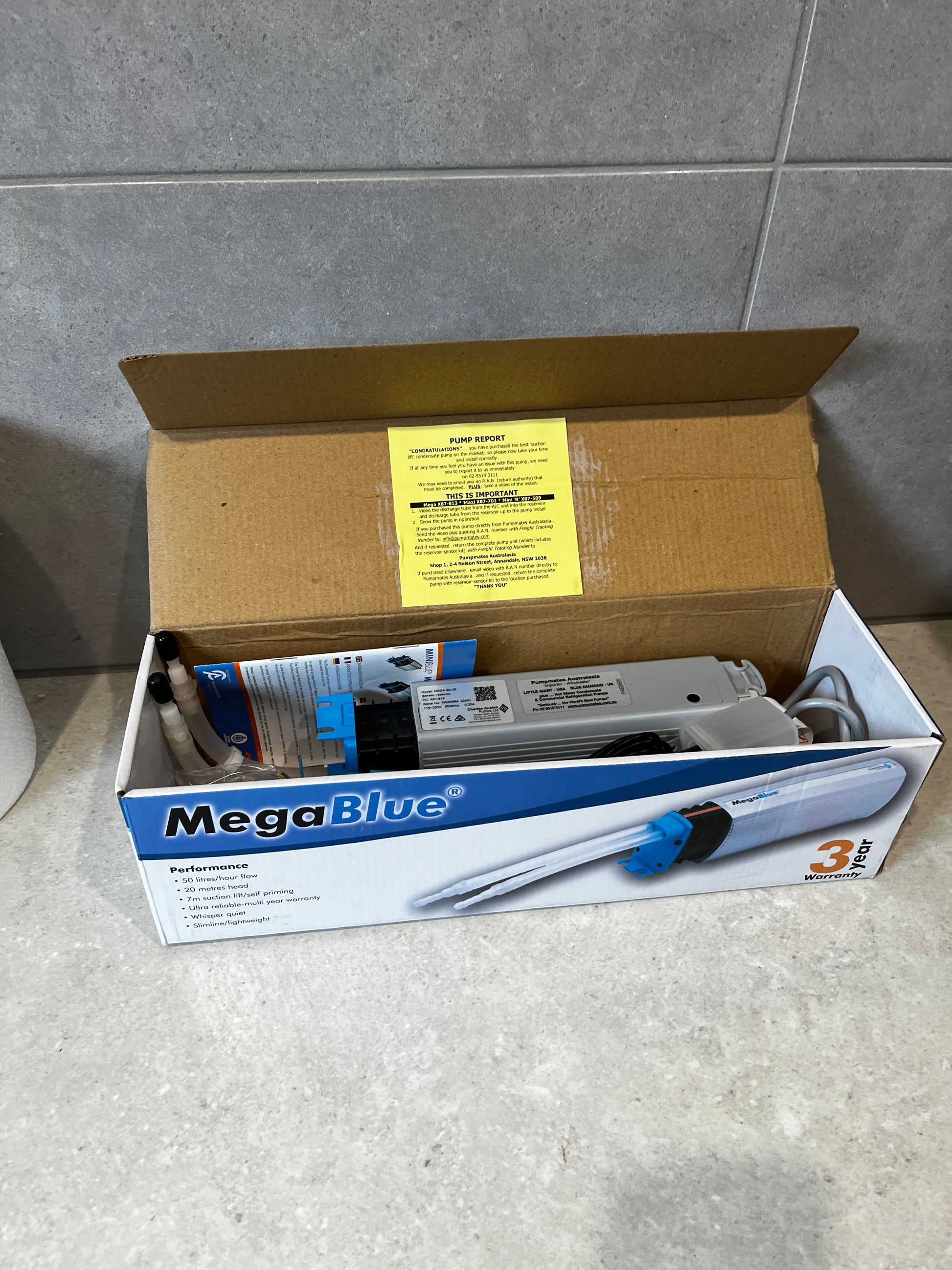 MegaBlue condensate pump kit in open box showing pump and accessories