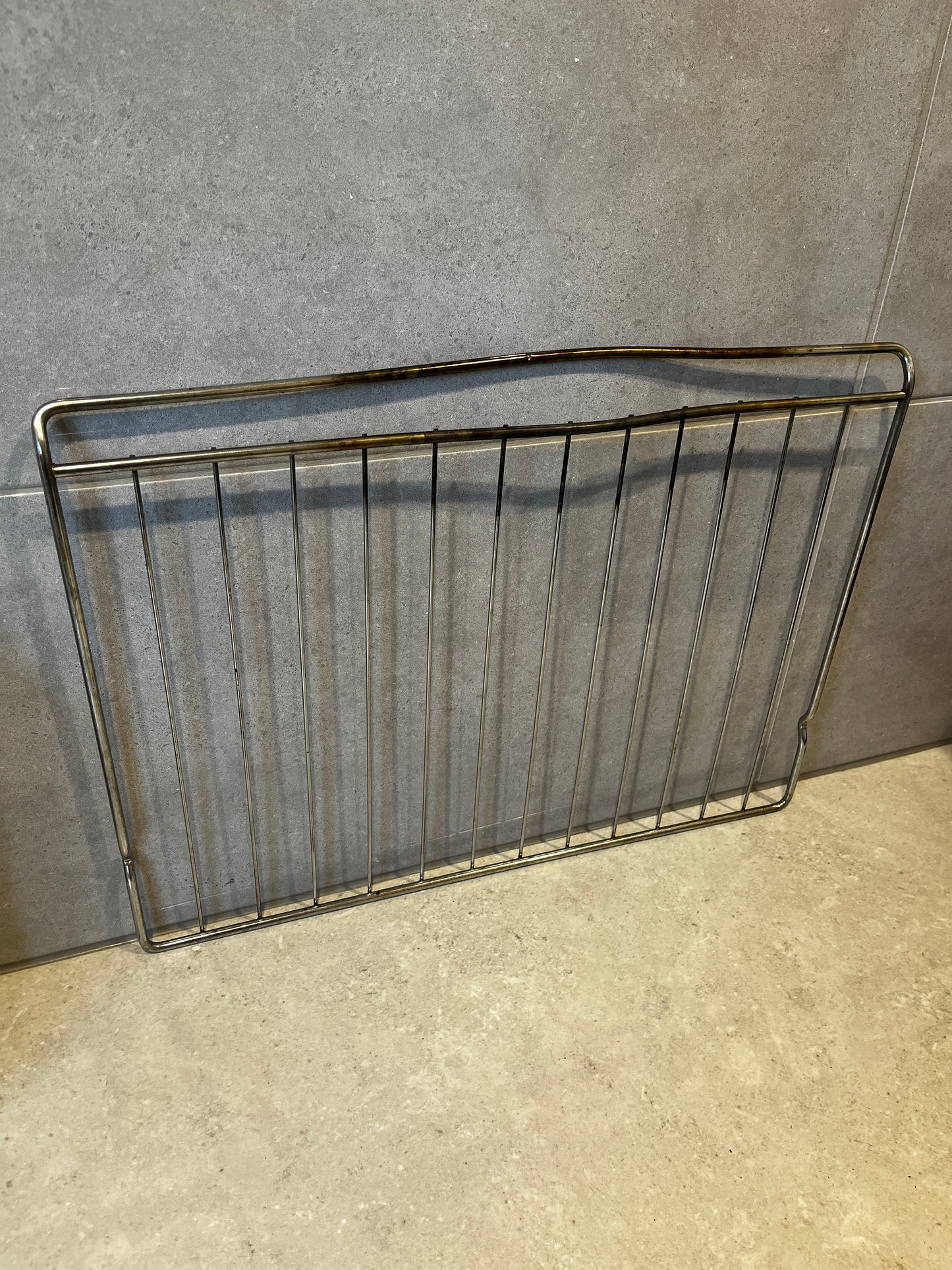 metal oven grill rack with multiple bars and sturdy design