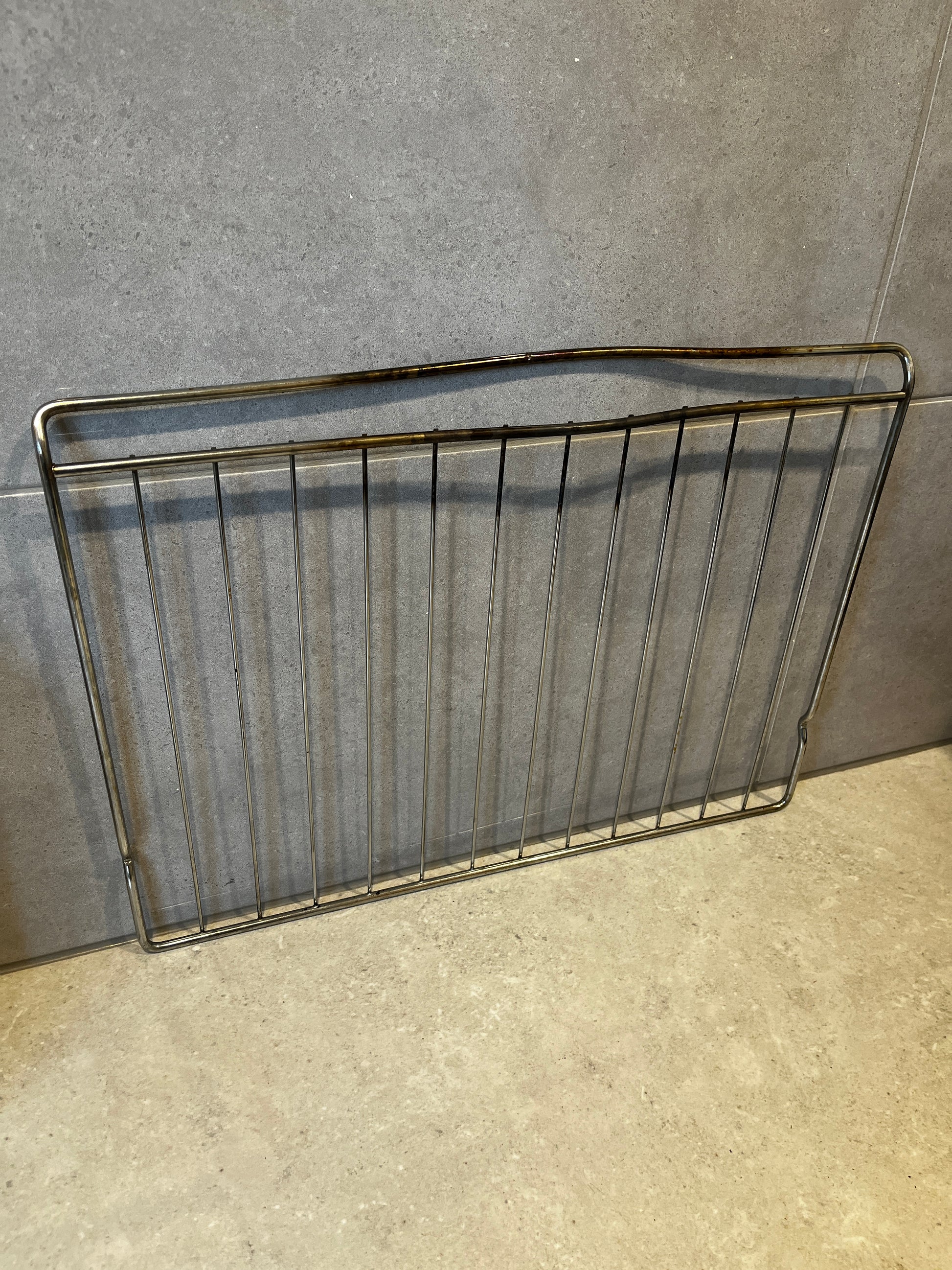 metal oven grill rack with multiple bars and sturdy design