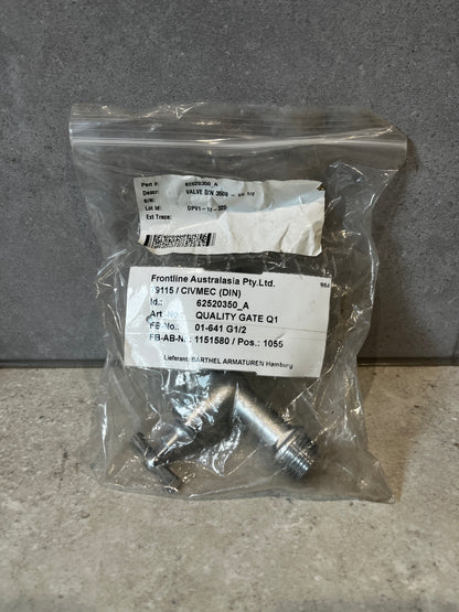 Stainless steel outdoor water tap in original packaging on a stone surface