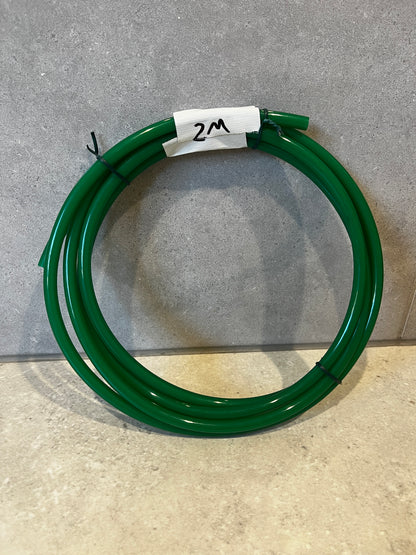 Coiled green polyurethane tube with 2-meter length label