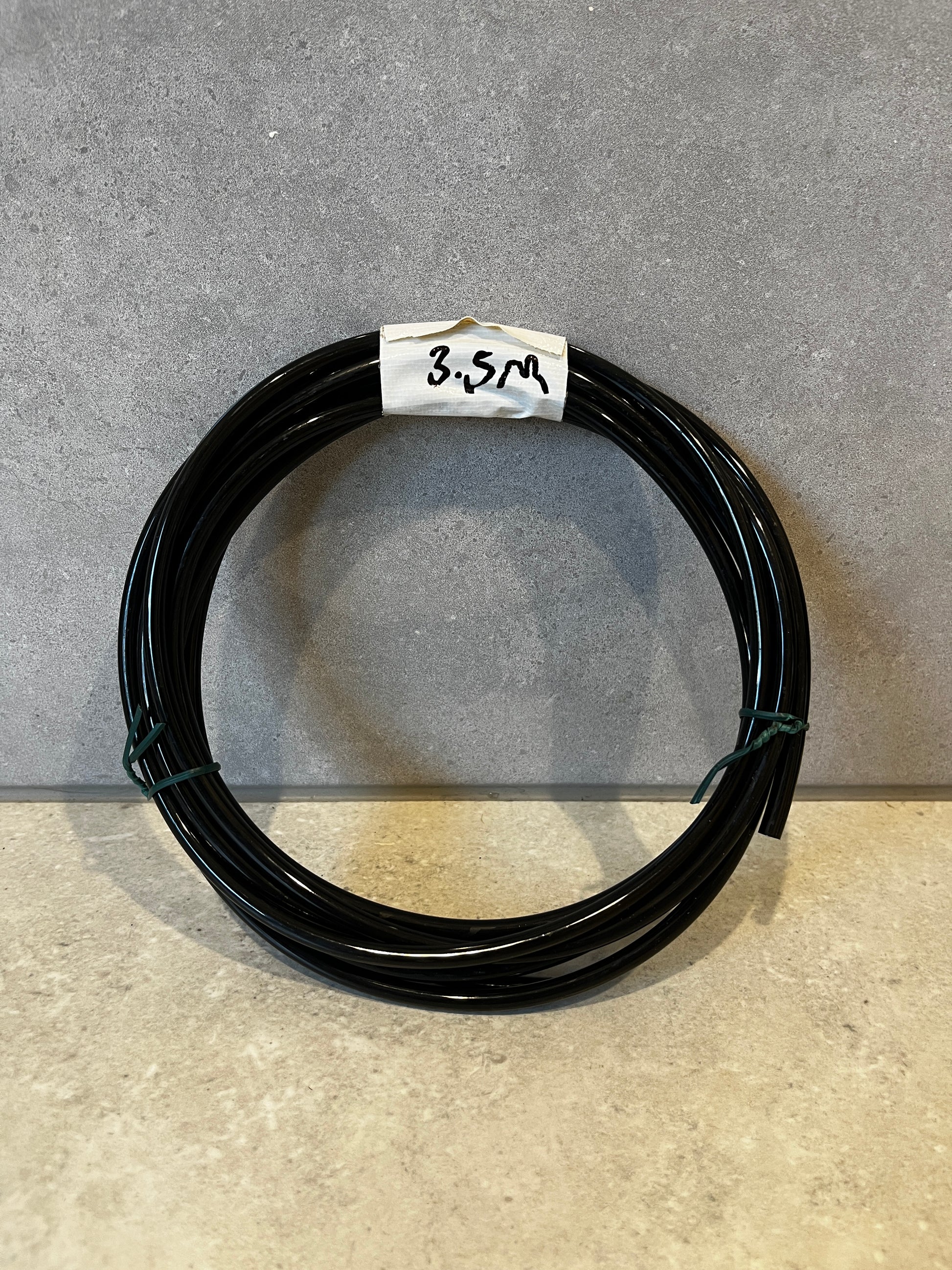 Black coil of polyurethane tubing labeled 3.5 meters