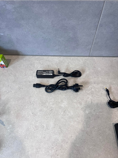 Chicony laptop power adapter and cable set on a countertop