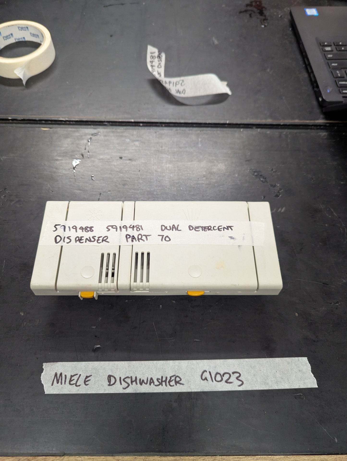 Front view of Miele G1023 dishwasher dual detergent dispenser part