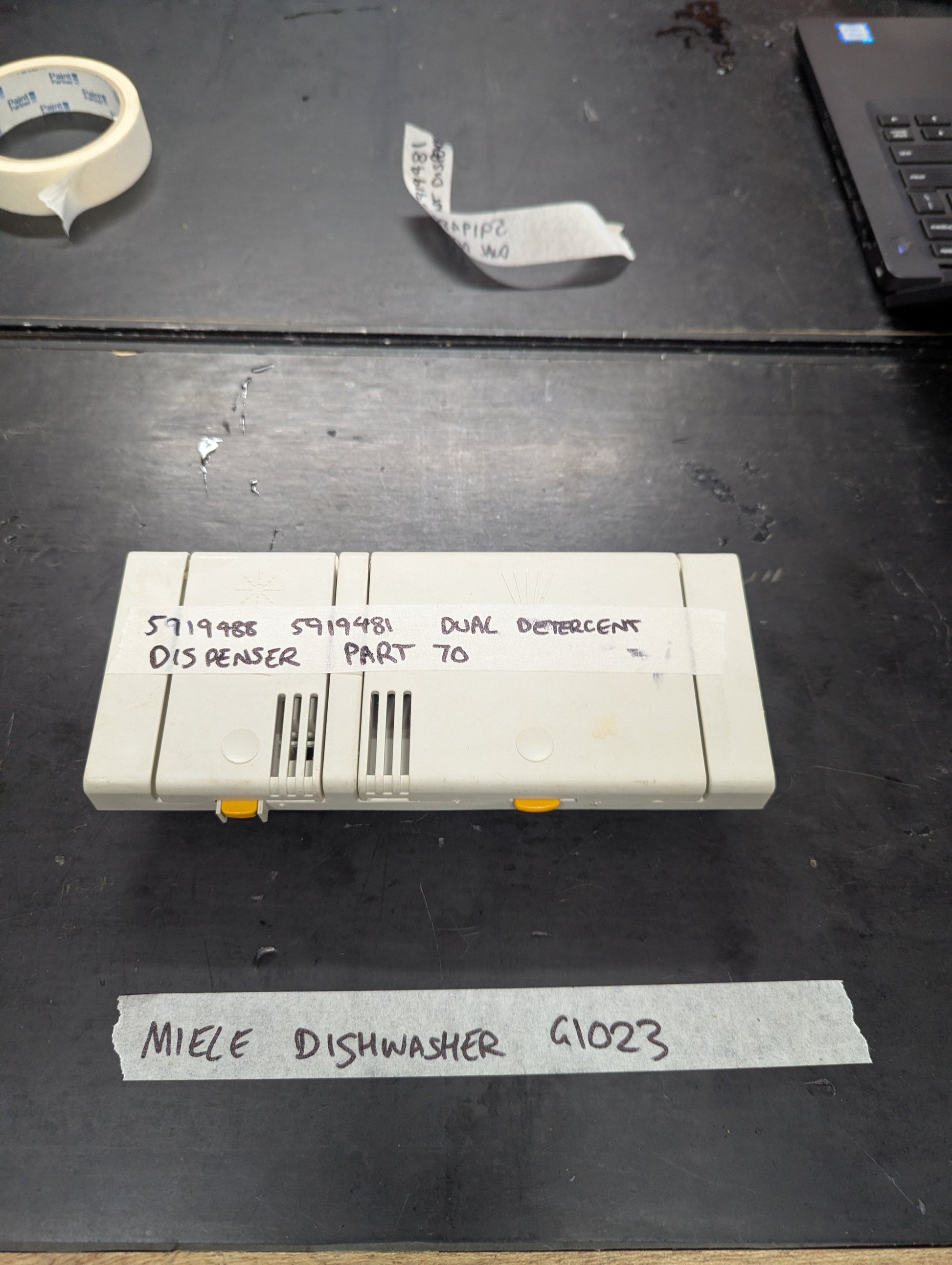 Front view of Miele G1023 dishwasher dual detergent dispenser part