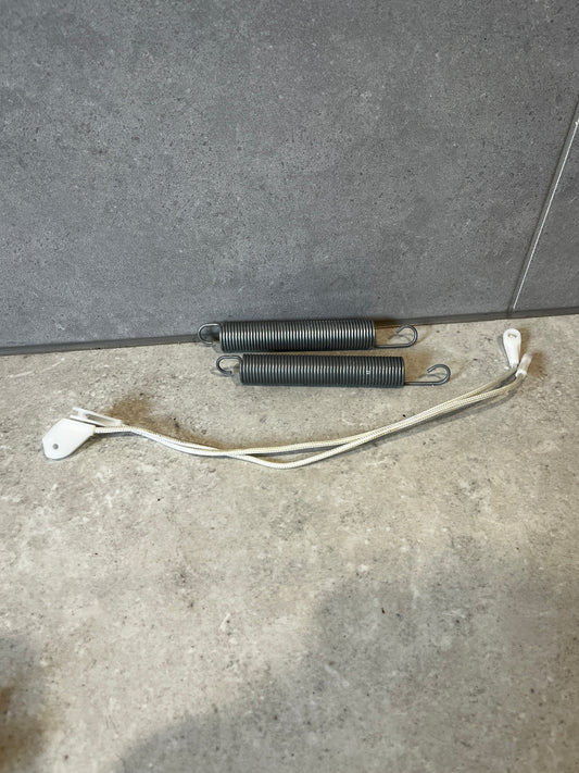 Appliance replacement door springs and braided nylon cable set on gray surface