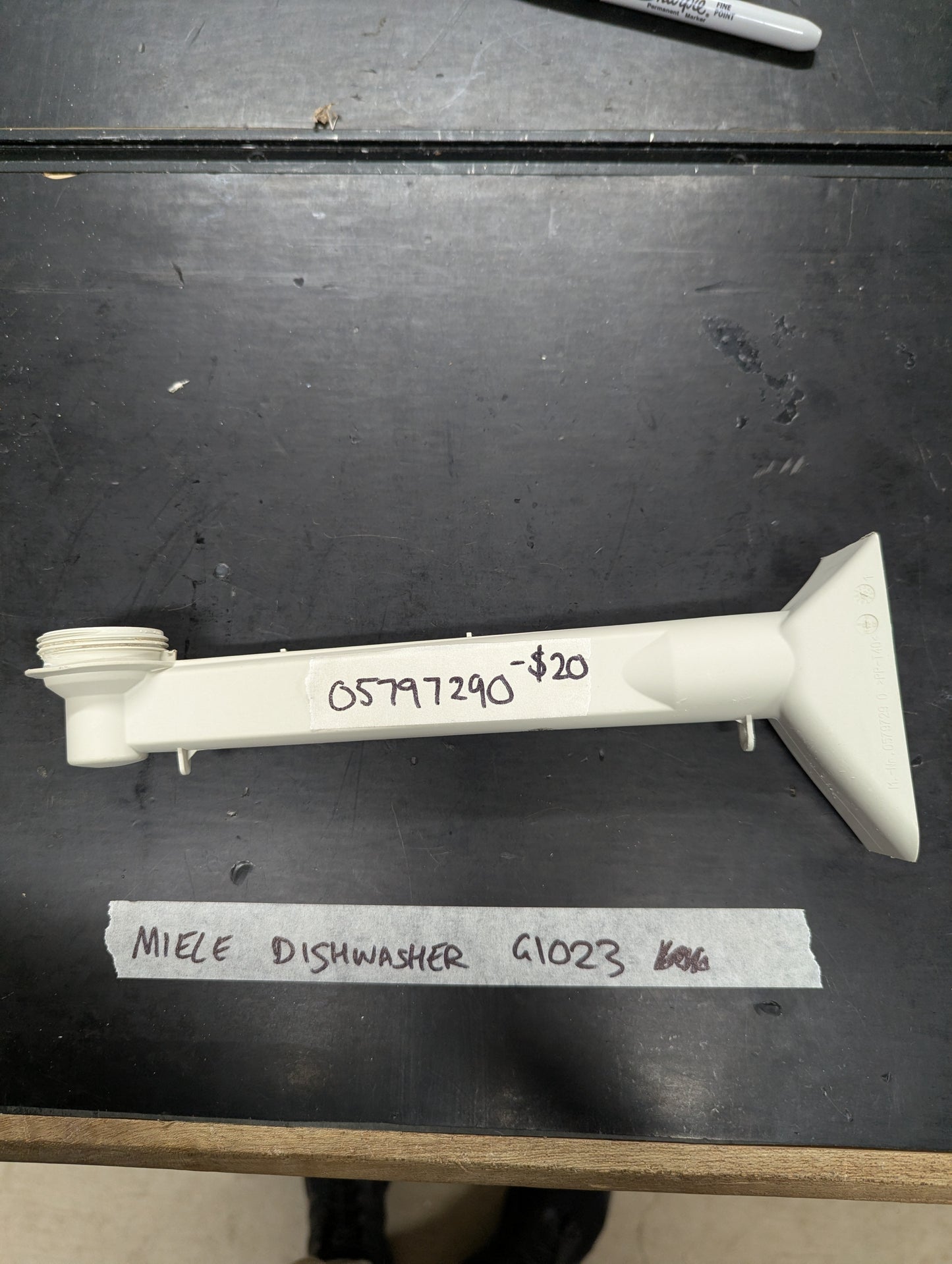 Miele G1023 dishwasher spray arm replacement on black background