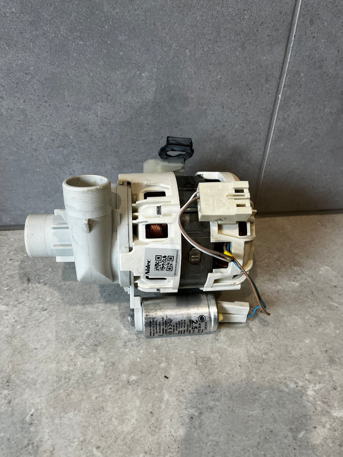 Side view of a washing machine drain pump motor assembly