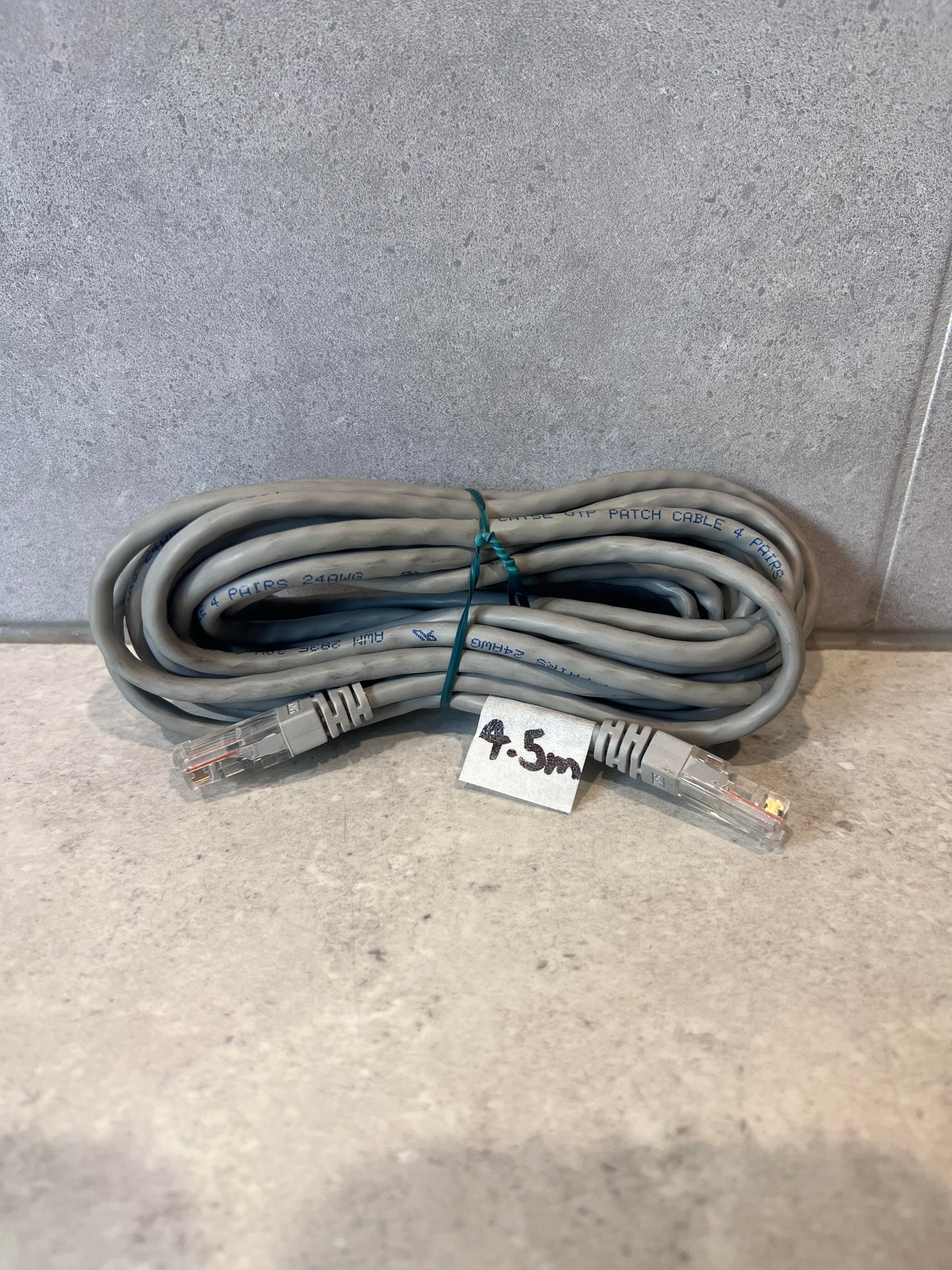 4.5 meter gray Ethernet patch cable with RJ45 connectors coiled on a countertop