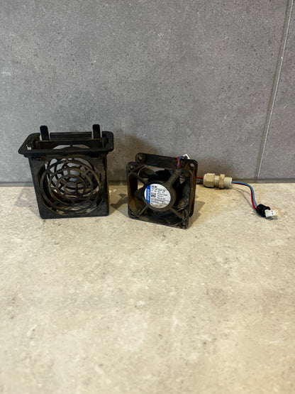 ebm-papst 632 NU 12V DC axial fan with protective housing and wiring on a stone surface