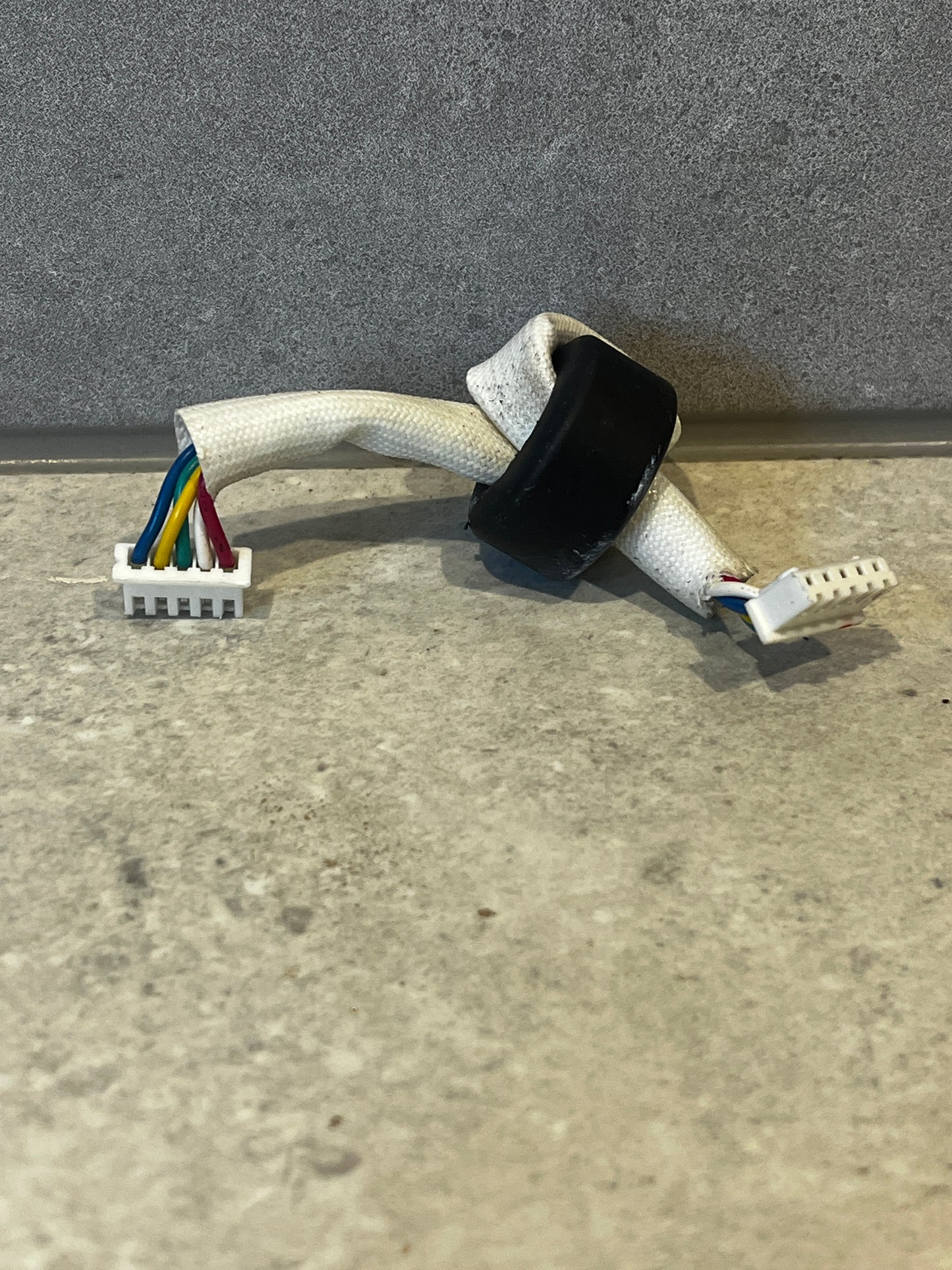 Multi-color wire harness connector with white braided sleeve and two plastic connectors