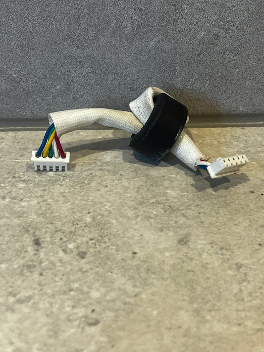 Multi-color wire harness connector with white braided sleeve and two plastic connectors