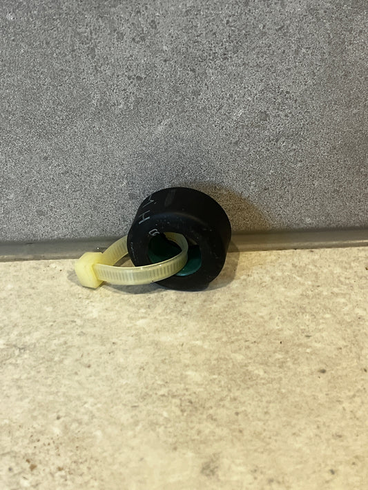 Rubber grommet with nylon cable tie on stone surface