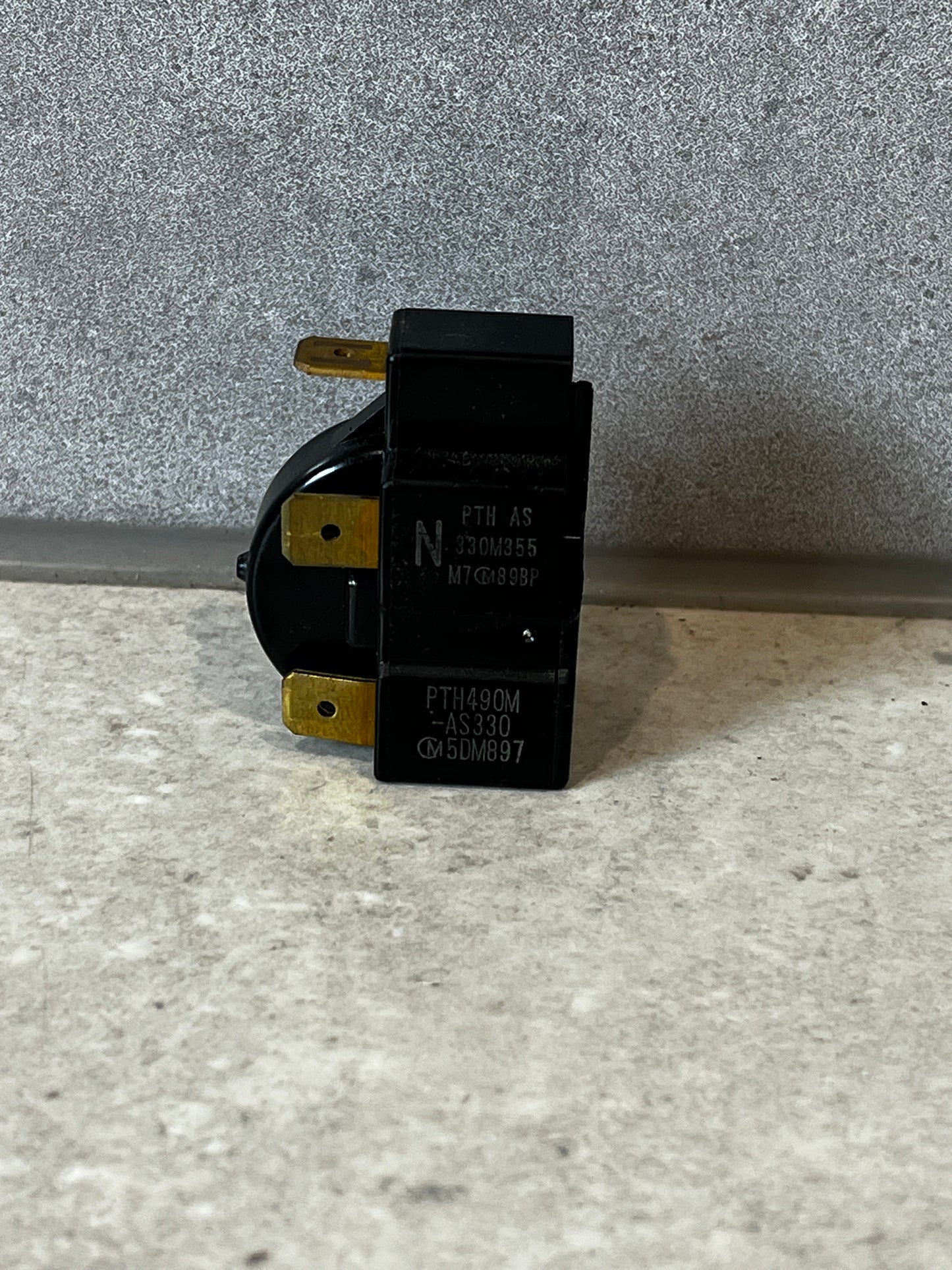 Heavy duty electrical relay switch on a stone surface