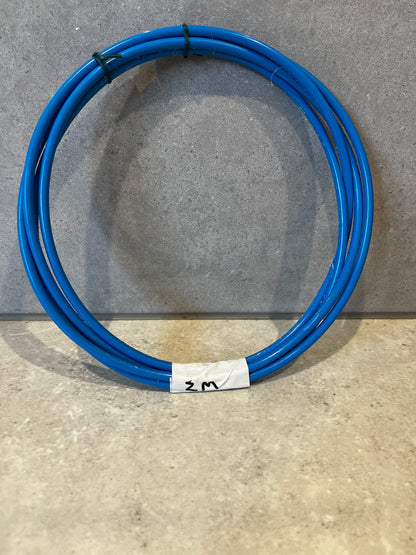 Coiled blue pneumatic tubing on grey surface with white label marking 2 meters