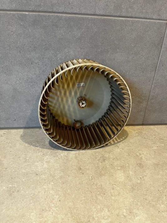 Round HVAC blower wheel fan with multiple blades against tiled background