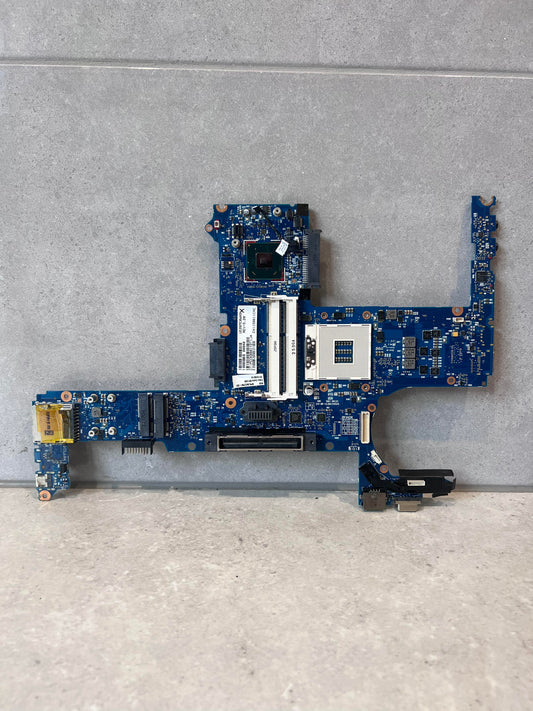 Front view of a blue laptop mainboard replacement part on a gray surface