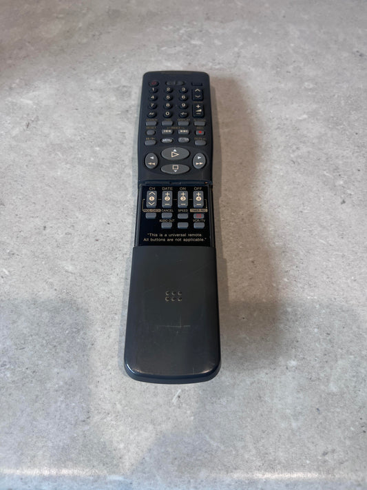 Universal remote control with sliding cover and multiple buttons on a countertop