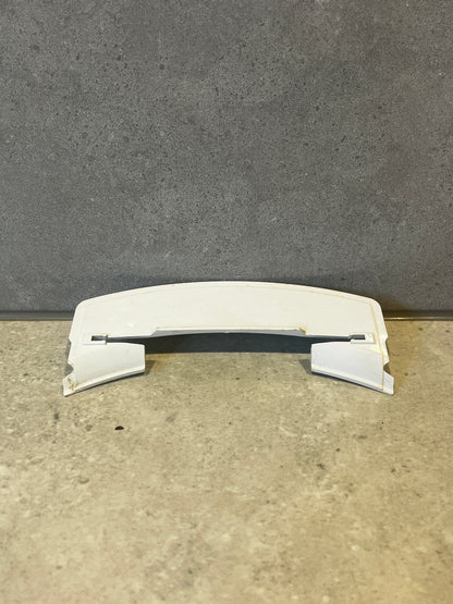 White curved ABS plastic appliance cover on a stone surface