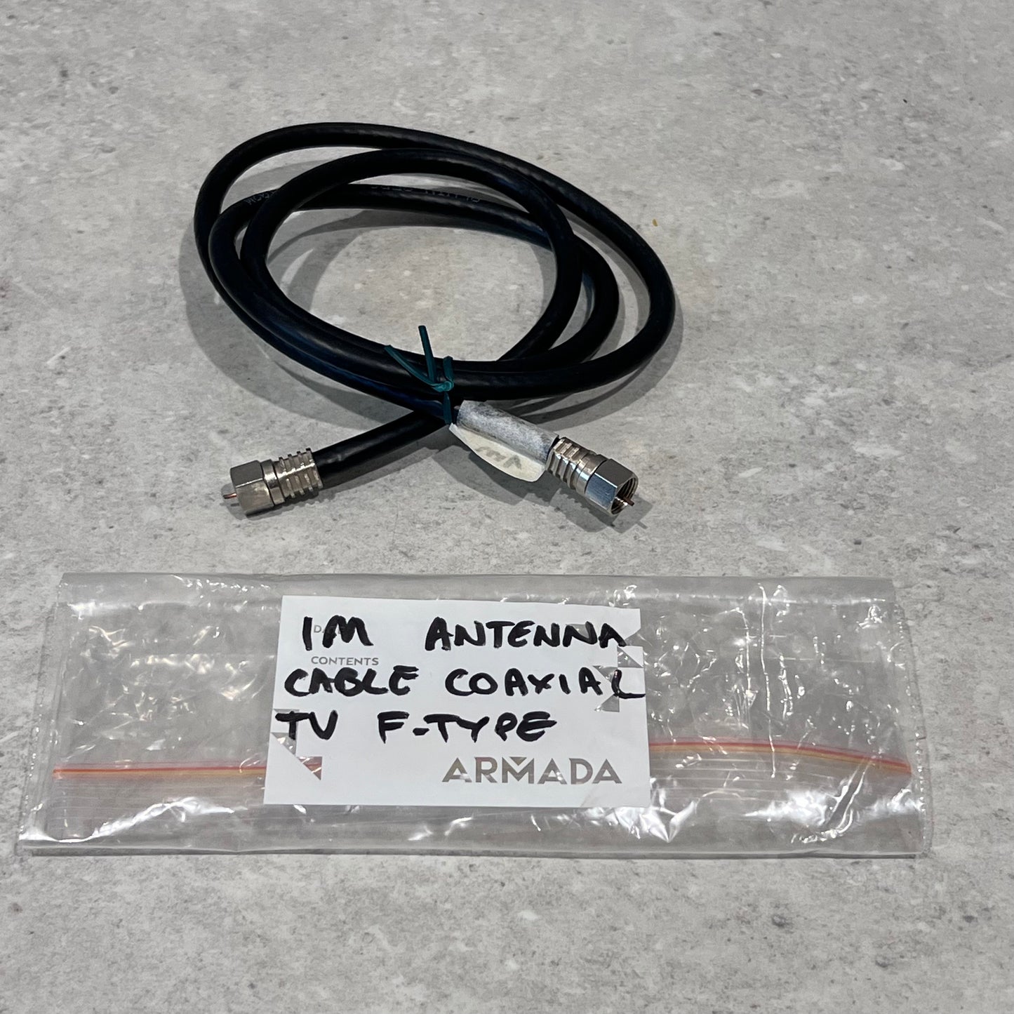1m coaxial antenna cable with F-type connectors and packaging on a gray surface