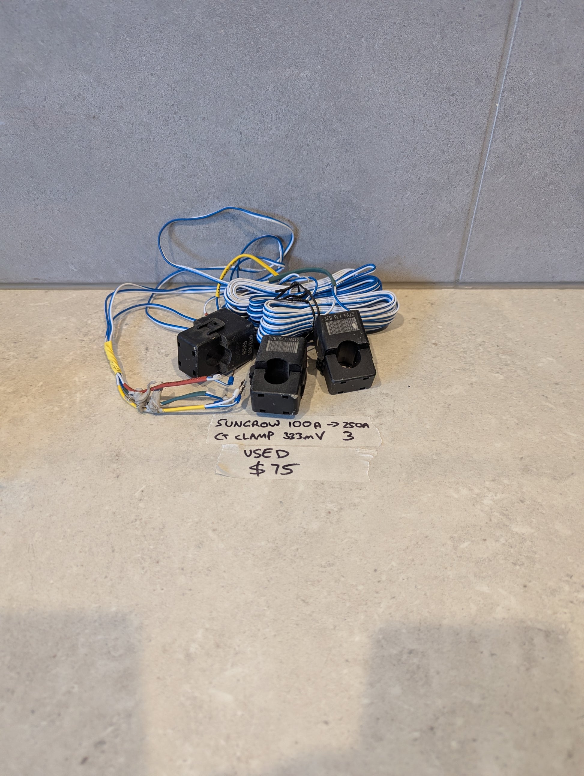 Used set of three Sungrow CT clamps with blue and white wires and handwritten price tag
