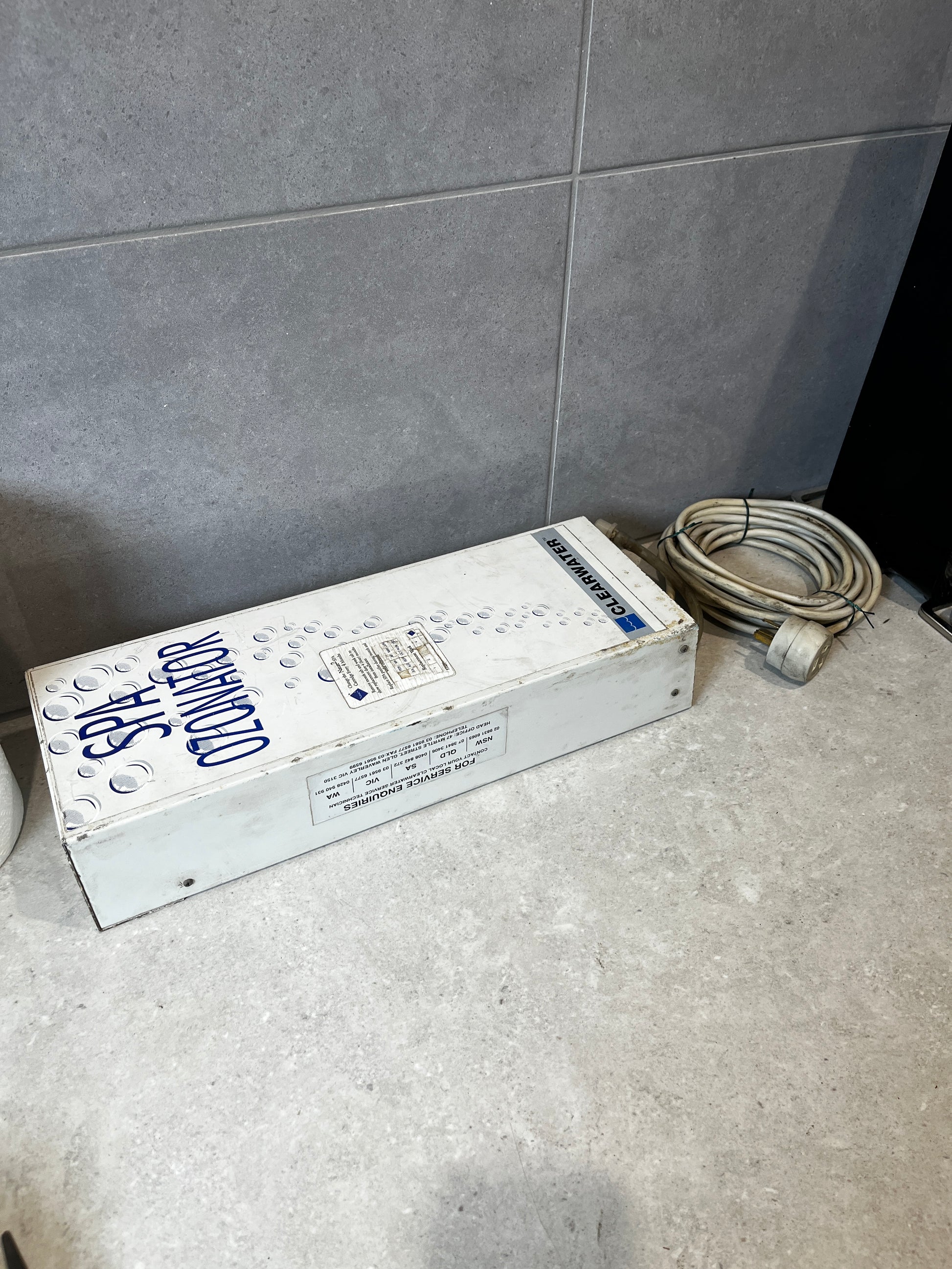 Clearwater spa ozonator device with cable on tile countertop