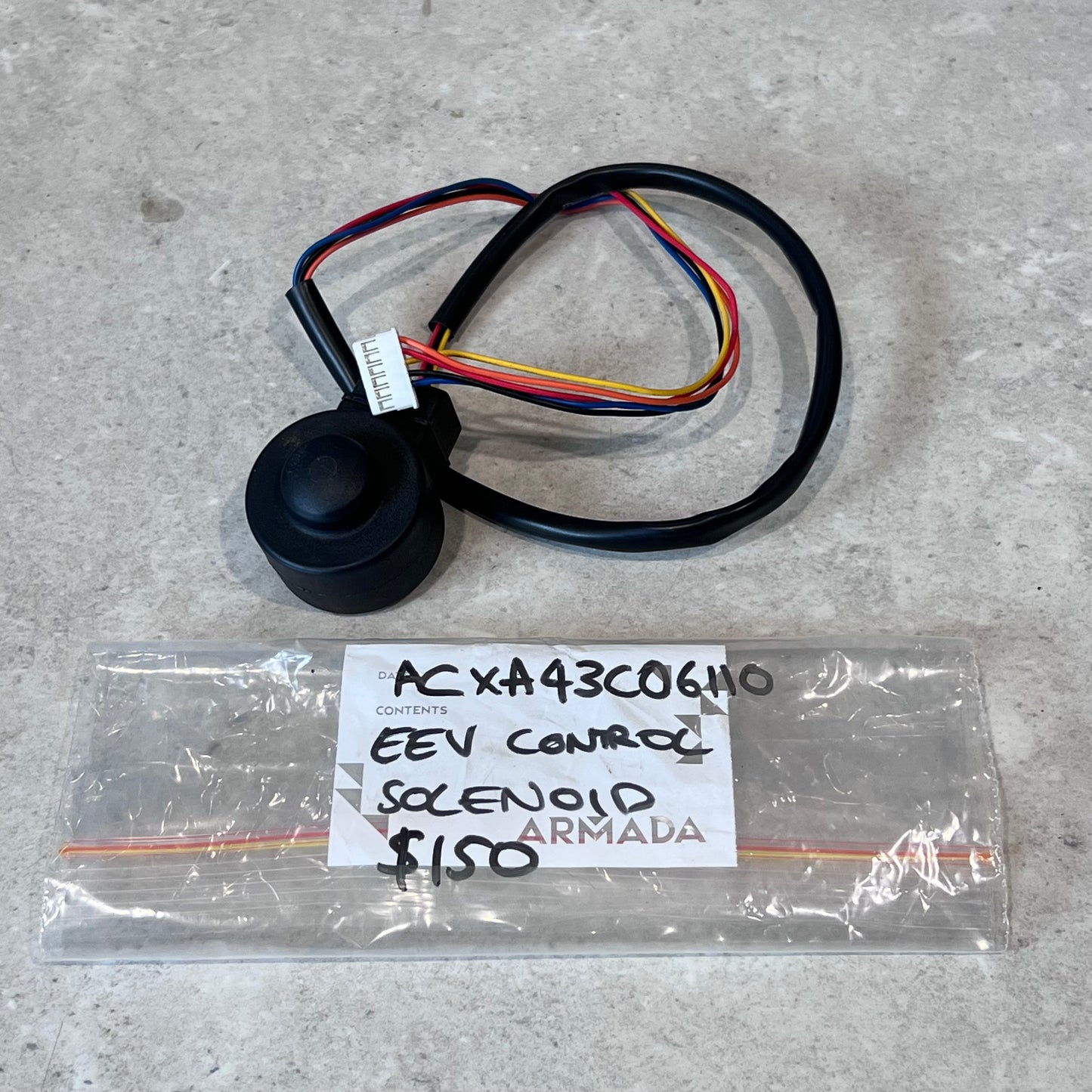Armada ACXA43C06410 EEV control solenoid with wire harness, placed beside labeled plastic bag